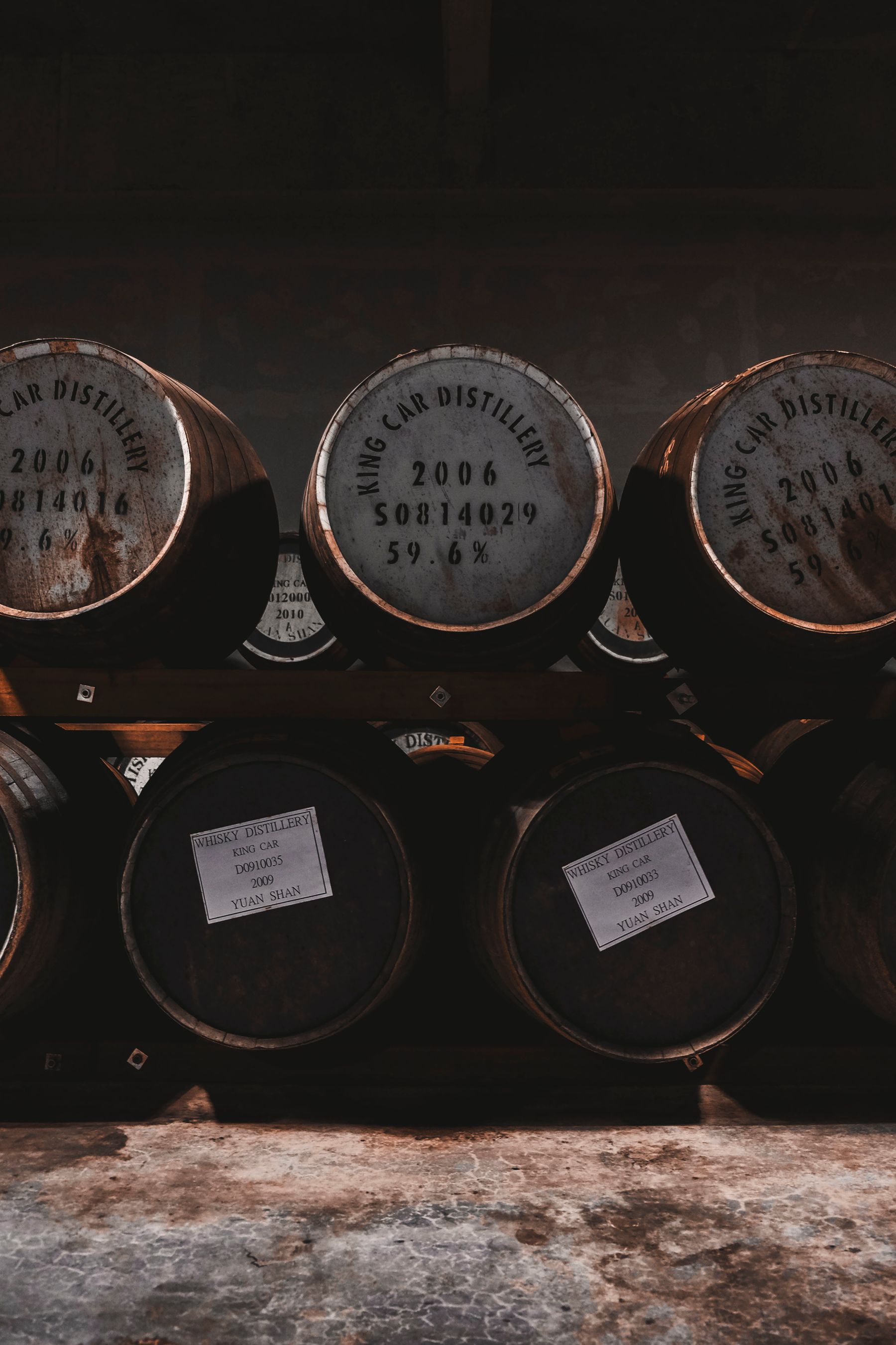 Old oak casks resting inside a traditional warehouse