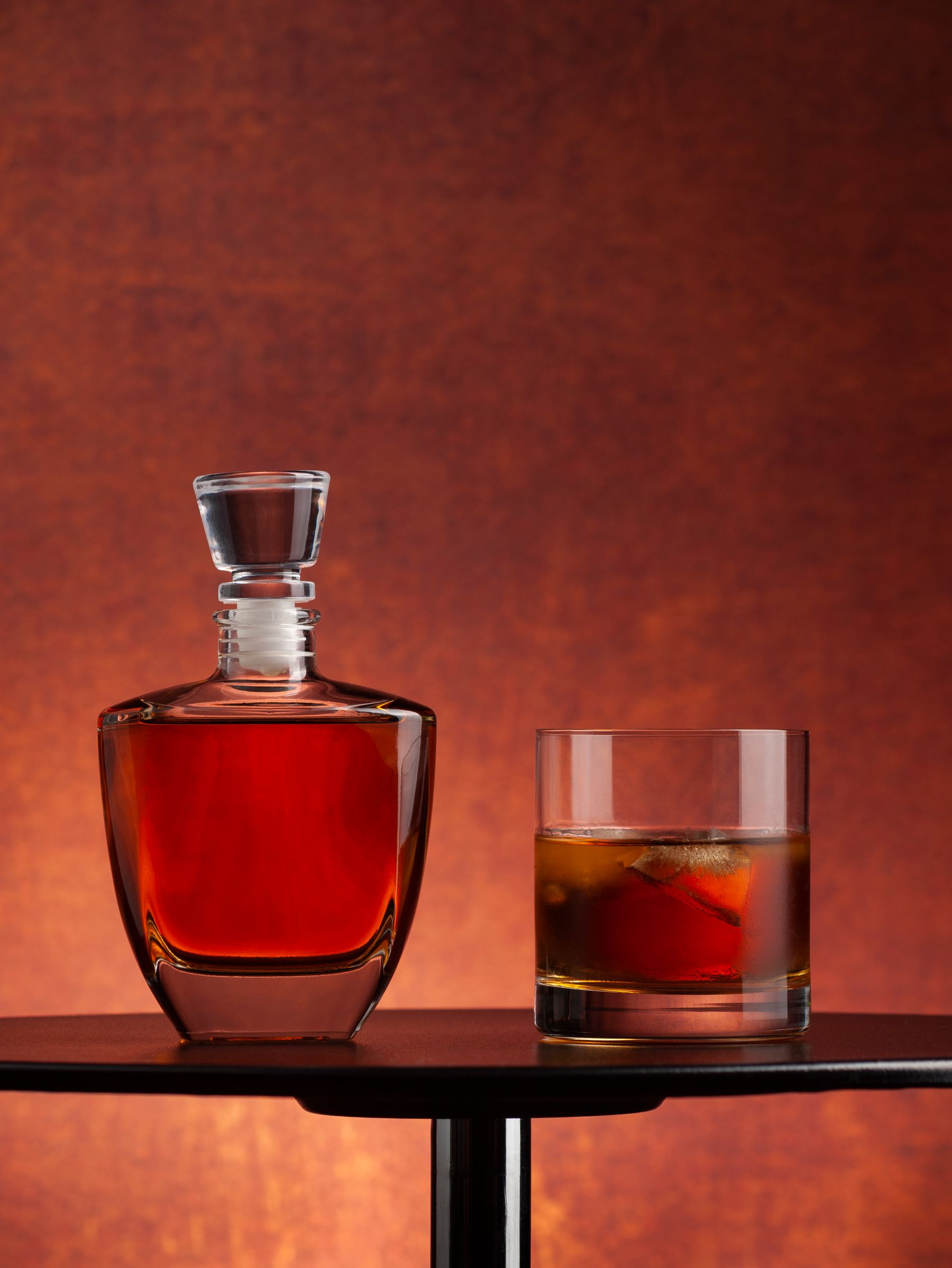 A whisky decanter and glass in warm evening light